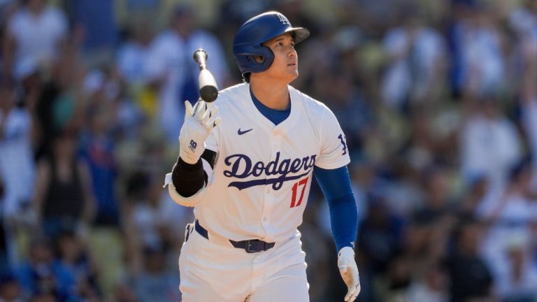 Los Angeles Dodgers designated hitter Shohei Ohtani tosses his bat after hitting a solo home run during the fifth inning of a baseball game against the Boston Red Sox, Sunday, July 21, 2024, in Los Angeles. (Ryan Sun/AP)