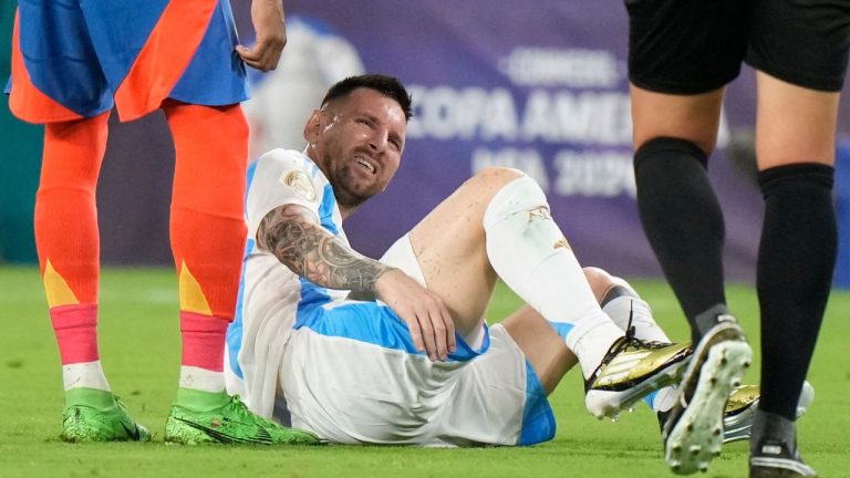 Argentina's Lionel Messi grimaces in pain after being injured during the Copa America final soccer match against Colombia in Miami Gardens, Fla., Sunday, July 14, 2024. (Wilfredo Lee/AP Photo)