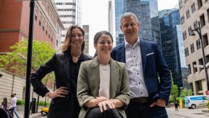 Diana Matheson, centre, former Canadian soccer player and CEO of Project 8 behind the creation of the Northern Super League, the Canadian Women's Professional Soccer League, is flanked by co-founders Isabele Chevalier, left and Jean-Francois Crevier. (CP/Christinne Muschi)