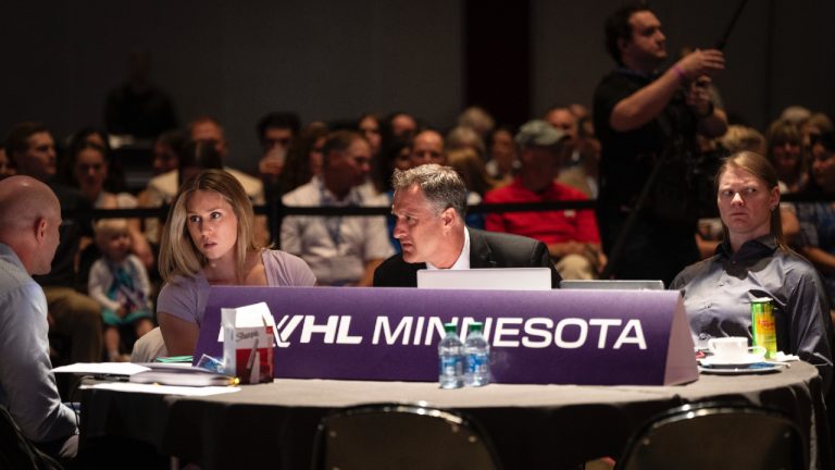 Minnesota head coach Ken Klee, centre, talks with other people at the Minnesota table before their first pick during the PWHL hockey draft in St. Paul, Minn., Monday June, 10, 2024. (Renée Jones Schneider/Star Tribune via AP)