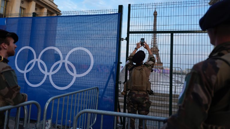 A soldier takes a photo of the Eiffel Tower as he patrols at the Trocadero plaza Thursday, July 18, 2024 in Paris. (David Goldman/AP)