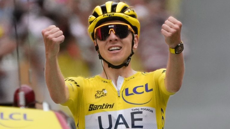 Stage winner Slovenia's Tadej Pogacar, wearing the overall leader's yellow jersey, celebrates as he crosses the finish line of the nineteenth stage of the Tour de France cycling race over 144.6 kilometers (89.9 miles) with start in Embrun and finish in Isola 2000, France, Friday, July 19, 2024. (Jerome Delay/AP)