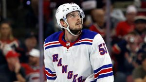 New York Rangers' Ryan Lindgren watches a replay of a power play goal by Carolina Hurricanes' Brady Skjei during the third period in Game 4 of an NHL Stanley Cup second-round playoff series, May 11, 2024. (AP Photo/Karl B DeBlaker)