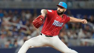 Pitcher Tanner Scott winds up during the ninth inning of a baseball game. (Marta Lavandier/AP)