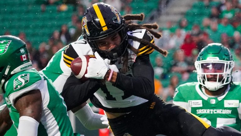 Hamilton Tiger-Cats' Shemar Bridges secures a catch against Saskatchewan Roughriders during the second half of CFL action, June 23, 2024. (Heywood Yu/CP)