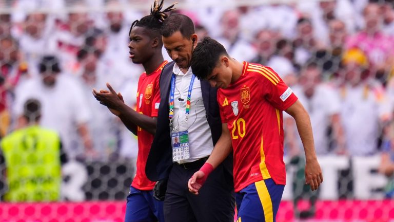 Spain's Pedri, right, leaves the pitch after suffering an injury during a quarter final match between Germany and Spain at the Euro 2024 tournament, July 5, 2024. (AP Photo/Manu Fernandez)