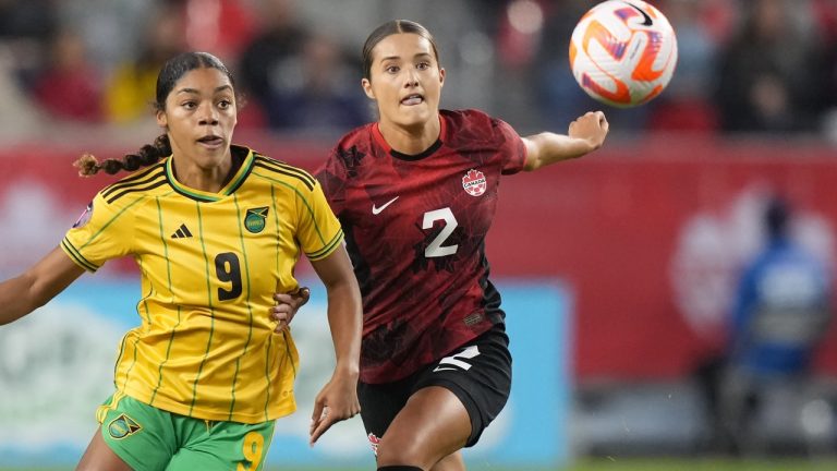 Canada's Sydney Collins, 2, battles Jamaica's Kameron Simmonds, 9,  for the ball during first half of CONCACAF women's championship series match Sept. 26, 2023. (THE CANADIAN PRESS/Nathan Denette)