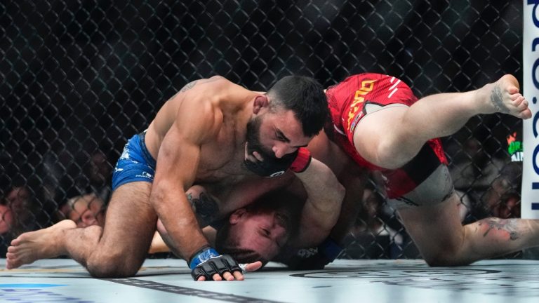 Benoit Saint Denis, of France, works against Matt Frevola, right, during the first round of a lightweight bout at UFC 295 on Nov. 11, 2023 in New York. Saint Denis won in the first round. (Frank Franklin II/AP)