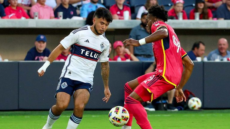 Vancouver Whitecaps' Ryan Raposo, left, moves the ball while under pressure from St. Louis City's Jayden Reid during the first half of an MLS soccer match Saturday, July 13, 2024, in St. Louis. (Scott Kane/AP)