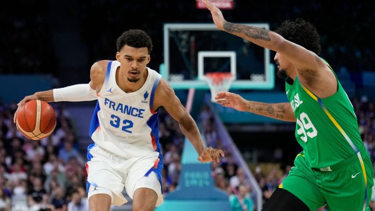 Victor Wembanyama, of France, drives on Lucas Dias, of Brazil, in a men's basketball game at the 2024 Summer Olympics, Saturday, July 27, 2024 in Villeneuve-d'Ascq, France. (Mark J. Terrill/AP Photo)