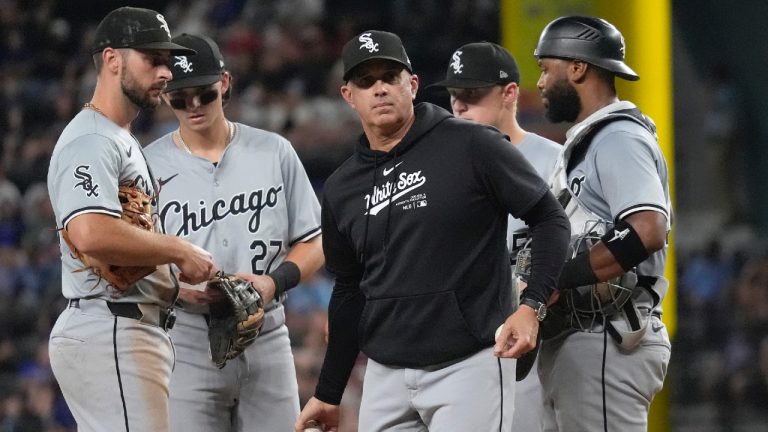 Chicago White Sox manager Pedro Grifol, centre, tosses a ball from the mound while standing with the infielders during a pitching substitution during the 8th inning of a baseball game against the Texas Rangers in Arlington, Texas, Wednesday, July 24, 2024. (LM Otero/AP)