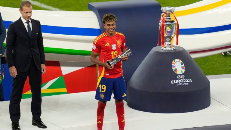 Spain's Lamine Yamal holds the young player of the tournament trophy after the final match between Spain and England at the Euro 2024 soccer tournament in Berlin, Germany, Sunday, July 14, 2024. (Andreea Alexandru/AP Photo)