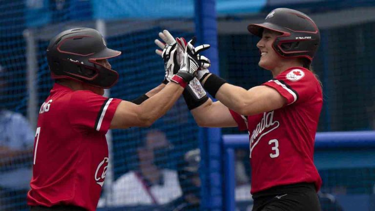 Canada’s Jennifer Salling, left, congratulates teammate Erika Polidori after they crossed the plate to score in the second inning against Mexico in the bronze medal game during the Tokyo Olympics, in Tokyo, Tuesday, July 27, 2021. (Adrian Wyld/CP)