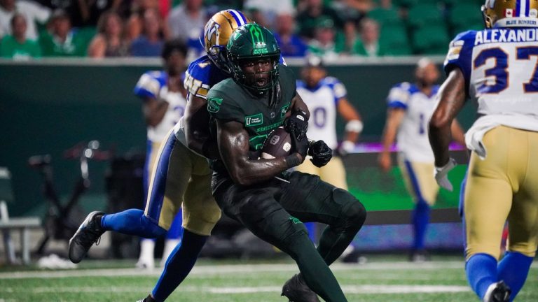 Saskatchewan Roughriders receiver Ajou Ajou (80) runs the football against Winnipeg Blue Bombers during the second half of CFL football action in Regina, on Friday, July 19, 2024. (Heywood Yu/CP)