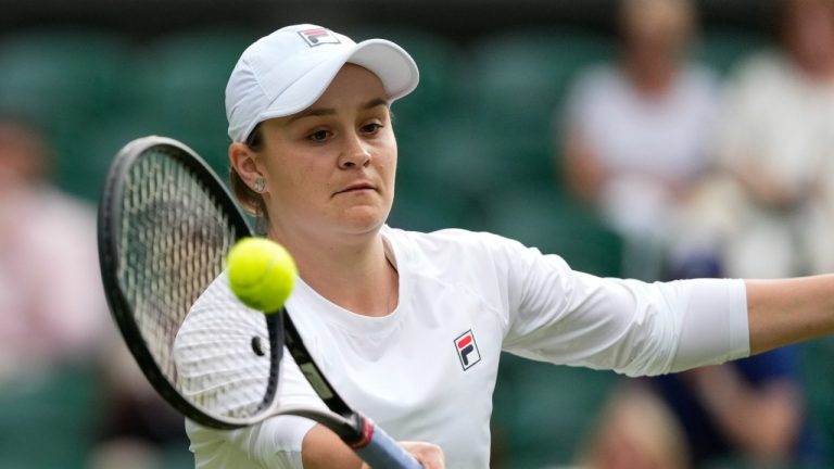 Australia's Ash Barty plays a forehand return during her invitation doubles match with compatriot Casey Dellacqua against Andrea Petkovic of Germany and Magdelena Rybarikova of Slovakia at the Wimbledon tennis championships in London, Wednesday, July 10, 2024. (Kirsty Wigglesworth/AP)