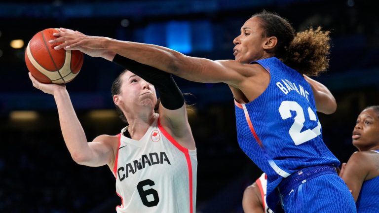 Bridget Carleton, of Canada, shoots over Marieme Badiane, of France, in a women's basketball game at the 2024 Summer Olympics, Monday, July 29, 2024, in Villeneuve-d'Ascq, France. (Mark J. Terrill/AP Photo)