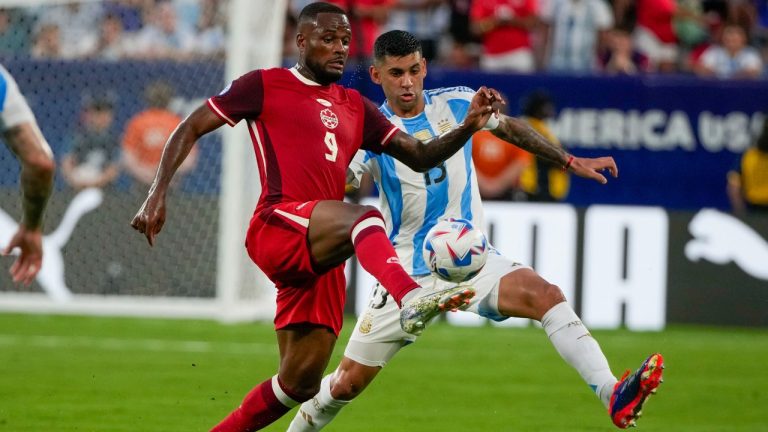 Canada's Cyle Larin and Argentina's Cristian Romero vie for the ball during a Copa America semifinal soccer match in East Rutherford, N.J., Tuesday, July 9, 2024. (Pamela Smith/AP Photo)