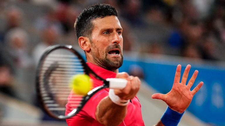 Serbian tennis player Novak Djokovic returns the ball against Matthew Ebden of Australia during the men's singles tennis competition, at the 2024 Summer Olympics, Saturday, July 27, 2024, in Paris, France. (Manu Fernandez/AP Photo)