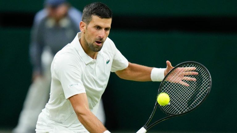 Novak Djokovic of Serbia plays a backhand return to Holger Rune of Denmark during their fourth round match at the Wimbledon tennis championships in London, Monday, July 8, 2024. (Mosa'ab Elshamy/AP)