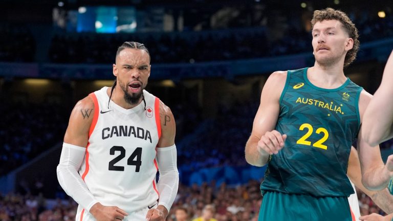 Canada's Dillon Brooks, left, celebrates after dunking as Australia's Will Magnay looks on in a men's basketball game at the 2024 Summer Olympics, Tuesday, July 30, 2024, in Villeneuve-d'Ascq, France. (Michael Conroy/AP Photo