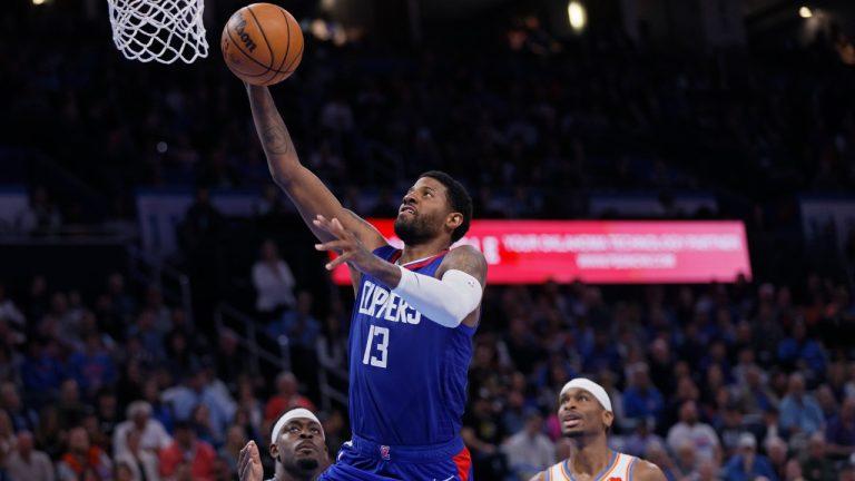 Los Angeles Clippers forward Paul George (13) prepares to shoot in front of Oklahoma City Thunder guards Luguentz Dort, left, and Shai Gilgeous-Alexander during the second half of an NBA basketball game, Thursday, Feb. 22, 2024, in Oklahoma City. (Nate Billings/AP)