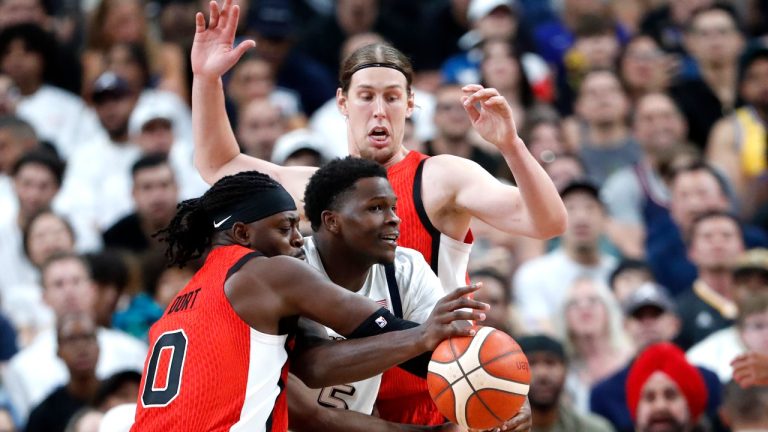 United States guard Anthony Edwards (5) gets caught between Canada point guard Luguentz Dort (0) and center Kelly Olynyk during the second half of an exhibition basketball game Wednesday, July 10, 2024, in Las Vegas. (Steve Marcus/AP Photo)