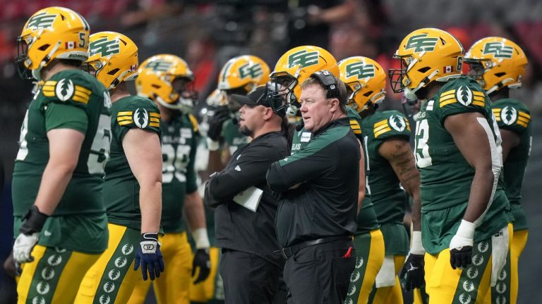 Edmonton Elks head coach Chris Jones, front centre, stands on the sideline during the second half of a pre-season CFL football game against the B.C. Lions, in Vancouver, on Friday, May 31, 2024. (Darryl Dyck/CP)