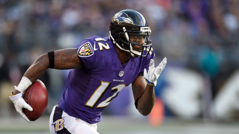 FILE - In this Nov. 30, 2014, file photo, Baltimore Ravens wide receiver Jacoby Jones carries the ball in the second half of an NFL football game against the San Diego Chargers in Baltimore. (Gail Burton/AP)