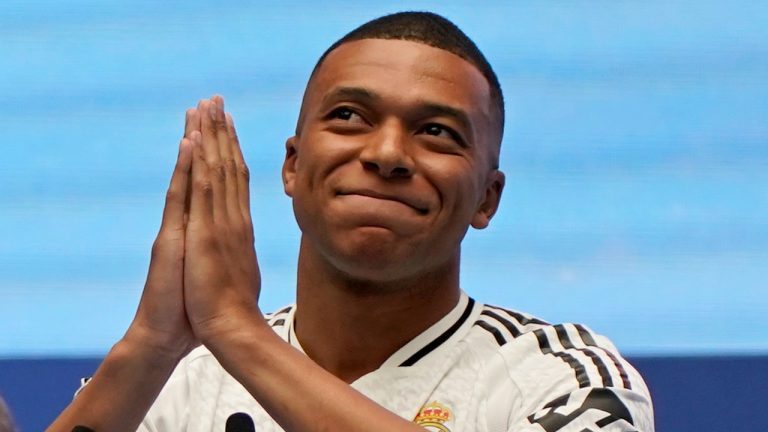 Kylian Mbappe, of France, gestures as he is presented to fans as a new Real Madrid player at the Santiago Bernabeu stadium in Madrid, Tuesday, July 16, 2024. (Andrea Comas/AP Photo)