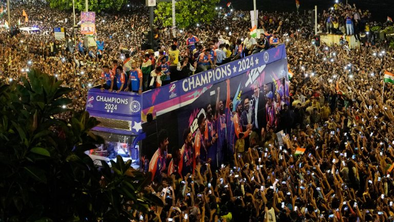 Crowds surround a double-decker bus as the India cricket team takes part in a parade celebrating their T20 Cricket World Cup win, Thursday, July 4, 2024, near Wankhede Stadium along Marin Drive in Mumbai, India. (Rajanish Kakade/AP)