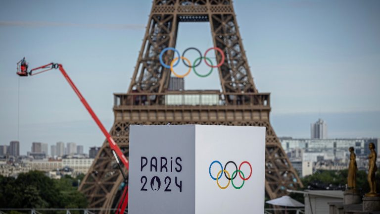 The Olympic rings are seen on the Eiffel Tower, Sunday, July 14, 2024, in Paris. The Paris Olympics organizers mounted the rings on the Eiffel Tower on Friday as the French capital marks 50 days until the start of the Summer Games. (Aurelien Morissard/AP)