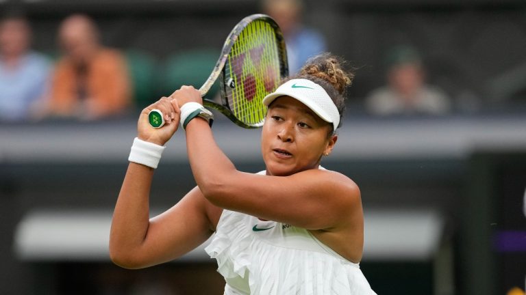 Naomi Osaka of Japan plays a backhand return to Emma Navarro of the United States during their match on day three at the Wimbledon tennis championships in London, Wednesday, July 3, 2024. (Alberto Pezzali/AP)