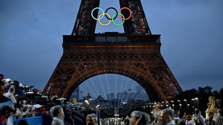 The Eiffel Tower and Olympic Rings are illuminated at the Trocadero during the opening ceremony for the 2024 Summer Olympics in Paris, France, Friday, July 26, 2024. (Loic Venance/Pool Photo via AP)