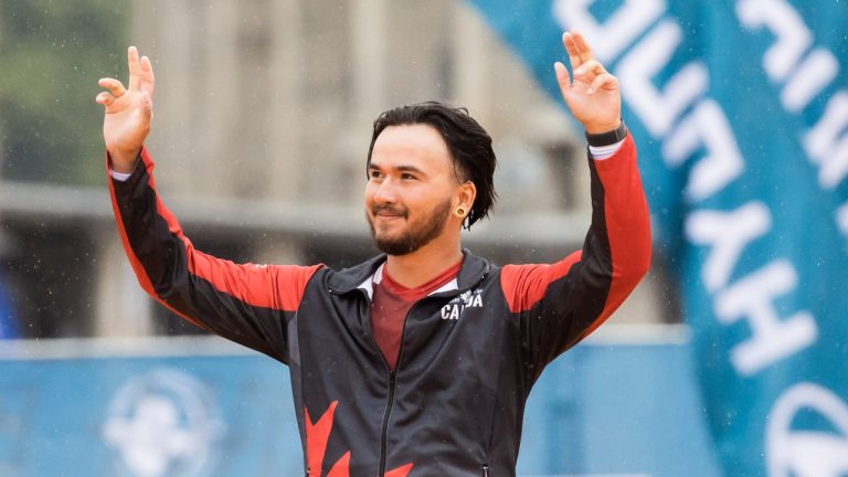 Eric Peters of Canada waves during the award ceremony for the men's recurve bow individual competition at the Archery World Championship in Berlin, Germany, Sunday, Aug. 6, 2023. (Christoph Soeder/dpa via AP)