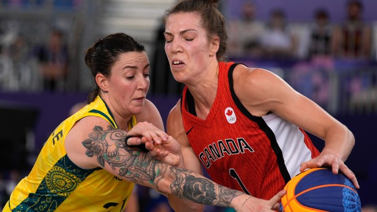 Michelle Plouffe of Canada, right, comes under pressure from Marena Whittle of Australia in the women's 3x3 basketball pool round match between Australia and Canada at the 2024 Summer Olympics, Tuesday, July 30, 2024, in Paris, France. (Rebecca Blackwell/AP Photo)