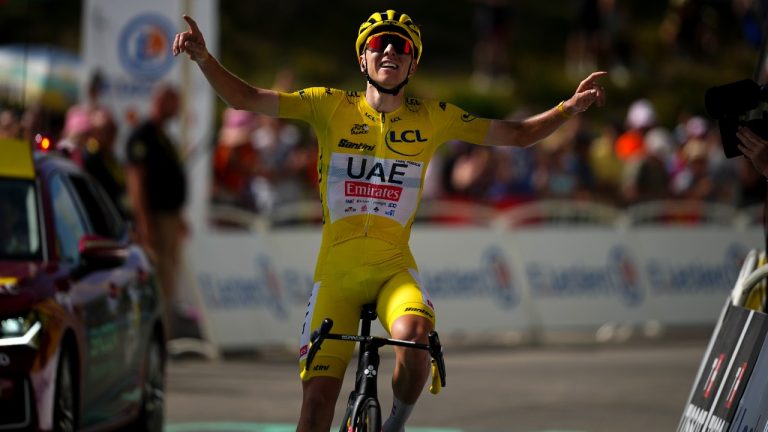 Stage winner Slovenia's Tadej Pogacar, wearing the overall leader's yellow jersey, celebrates as he crosses the finish line of the fifteenth stage of the Tour de France cycling race over 198 kilometres (123 miles) with start in Loudenvielle and finish on Plateau de Beille, France, Sunday, July 14, 2024. (Daniel Cole/AP)