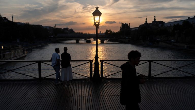 The sun sets over the Seine river next to the Louvre museum, at right, during the 2024 Summer Olympics, Saturday, July 27, 2024, in Paris. (David Goldman/AP Photo)