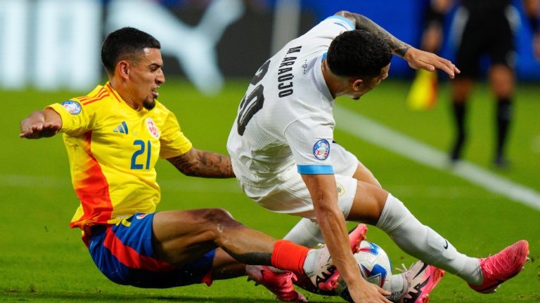 Colombia's Daniel Munoz (21) and Uruguay's Maximiliano Araujo battle for the ball during a Copa America semifinal soccer match in Charlotte, N.C., Wednesday, July 10, 2024. (Jacob Kupferman/AP)