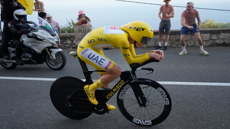 Slovenia's Tadej Pogačar, wearing the overall leader's yellow jersey, rides during the twenty-first stage of the Tour de France cycling race, an individual time trial over 33.7 kilometers (20.9 miles) with start in Monaco and finish in Nice, France, Sunday, July 21, 2024. (Jerome Delay/AP)