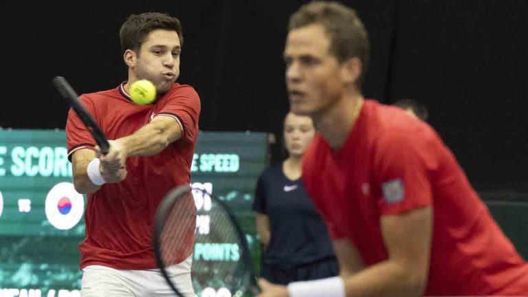 Canada's Alexis Galarneau advanced to the second round of qualifying at the National Bank Open with a 6-4, 6-4 victory over Facundo Diaz Acosta of Argentina on Sunday. Galarneau hits a return, as teammate Vasek Pospisil looks on, to Nam Jisung and Song Minkyu of South Korea during their Davis Cup tennis qualifier match in Montreal, Saturday, Feb. 3, 2024. (Christinne Muschi/CP)