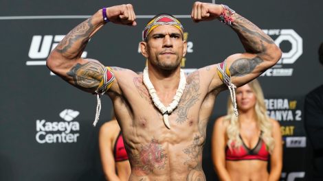 Alex-Pereira-raises-his-fists-during-a-UFC-ceremonial-weigh-in