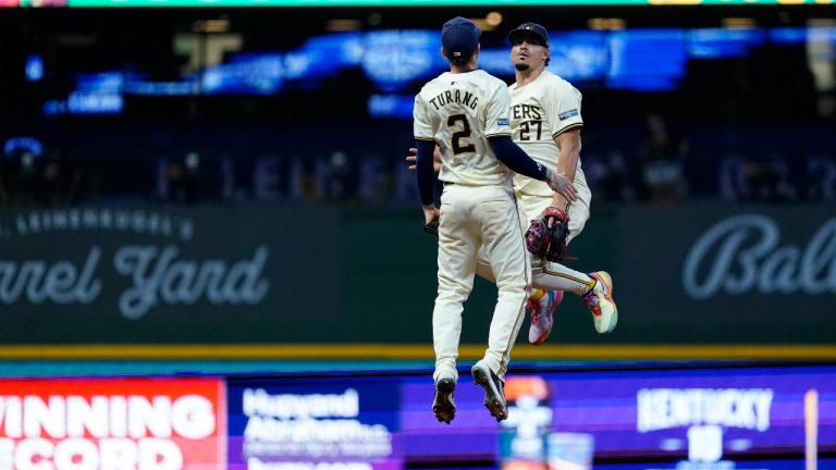 Milwaukee Brewers' Willy Adames (27) celebrates with Brice Turang (2) after a baseball game against the Los Angeles Dodgers, Wednesday, Aug. 14, 2024, in Milwaukee. (Aaron Gash/AP)