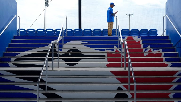 An usher waits for fans to arrive at TD Ballpark before a spring training baseball game between the Toronto Blue Jays and the Philadelphia Phillies Monday, March 4, 2024, in Dunedin, Fla. (Charlie Neibergall/AP Photo)