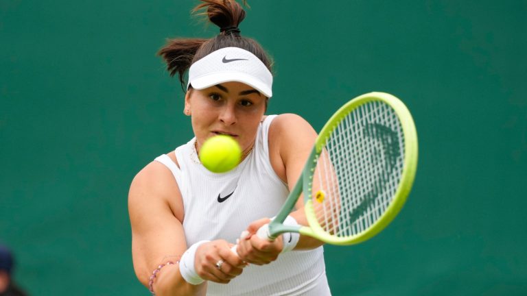 Bianca Andreescu of Canada plays a backhand return to Linda Noskova of the Czech Republic during their match on day three at the Wimbledon tennis championships in London, Wednesday, July 3, 2024. (AP Photo/Kirsty Wigglesworth) 