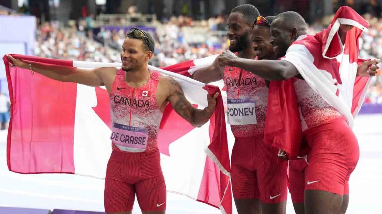 Canada's men's 4 x 100m relay team, from left to right, Andre De Grasse, Brendon Rodney, Aaron Brown and Jerome Blake celebrate their gold medal finish during the Paris Summer Olympics in Saint-Denis, France, Friday, Aug. 9, 2024. (Nathan Denette/CP)