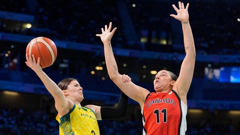 Australia's Jade Melbourne, left, shoots as Canada's Natalie Achonwa defends during a women's basketball game at the 2024 Summer Olympics, Thursday, Aug. 1, 2024, in Villeneuve-d'Ascq, France. (AP Photo/Michael Conroy)