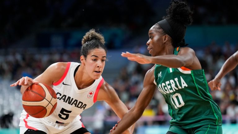 Kia Nurse (5), of Canada, drives around Promise Amukamara (10), of Nigeria, in a women's basketball game at the 2024 Summer Olympics, Sunday, Aug. 4, 2024, in Villeneuve-d'Ascq, France. (AP Photo/Mark J. Terrill)