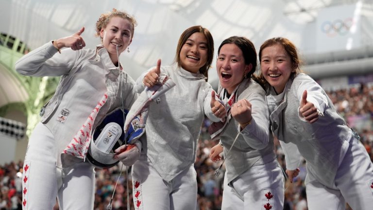 Canada's fencers celebrate after winning the women's team foil quarterfinal match against France during the 2024 Summer Olympics at the Grand Palais, Thursday, Aug. 1, 2024, in Paris, France. (Rebecca Blackwell/AP)