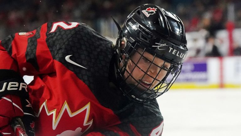 Canada's Claire Thompson battles along the boards against the United States during first period Rivalry Series action in Kamloops, B.C., Nov. 17, 2022. (THE CANADIAN PRESS/Jesse Johnston)