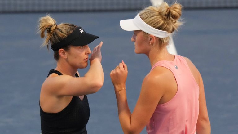 Gabriela Dabrowski of Canada (left) and doubles partner Erin Routliffe confer during their match against Magda Linette of Poland and Peyton Stearns fo the United States at the National Bank Open in Toronto on Friday, August 9, 2024. (Chris Young/CP)